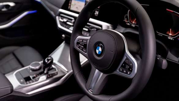 BMW 3 Series Sedan, Variable sport steering. Detailed side view of the cockpit of the BMW 3 Series Sedan with focus on the steering wheel with variable sport steering.