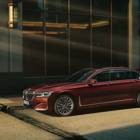 BMW Individual 7 Series Sedan, side view BMW Individual 7 Series Sedan in red in side view in front of urban setting