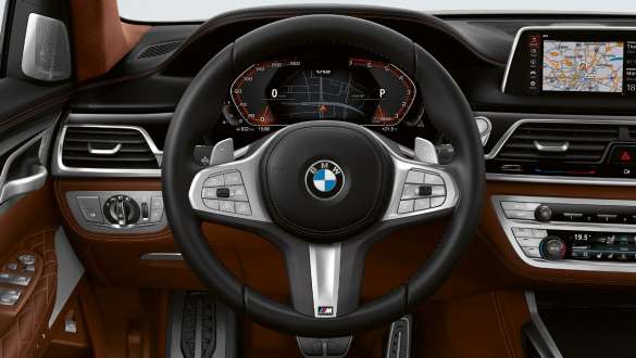 BMW M760Li xDrive Sedan G11 G12 2019 Frozen Dark Silver metallic three-quarter front view in urban setting Integral Active Steering BMW M760Li xDrive Sedan G11 G12 2019 Frozen Dark Silver metallic three-quarter front view in urban setting Integral Active Steering