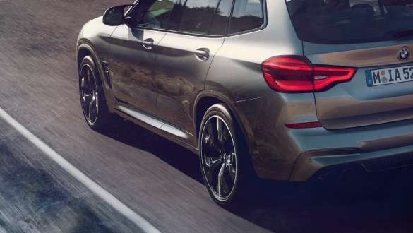 BMW X3 M Competition SUV F97, three-quarter rear view. BMW X3 M Competition SUV F97 in Donington Grey metallic, exterior, three-quarter front view, M specific suspension.