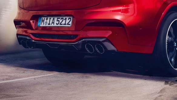 M Sport exhaust system F98. BMW X4 M Competition SUV F98 in Toronto Red metallic, exterior, rear view with M Sport exhaust system and diffusor in carbon.