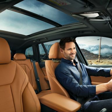 BMW X3 M40i SUV G01, cockpit with man at the wheel BMW X3 M40i SUV G01, cockpit with man at the wheel