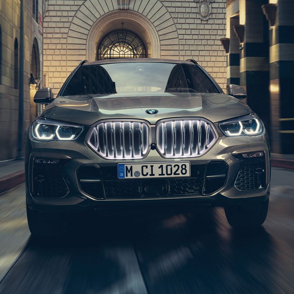 BMW X6 SUV G06 with BMW ‘Iconic Glow’ kidney grille. BMW X6 SUV G06 in front view in urban setting.