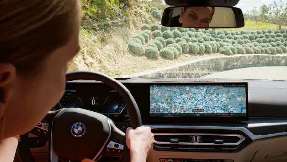 Person in the vehicle looks at the curved display Person in the vehicle looks at the curved display Screen with navigation