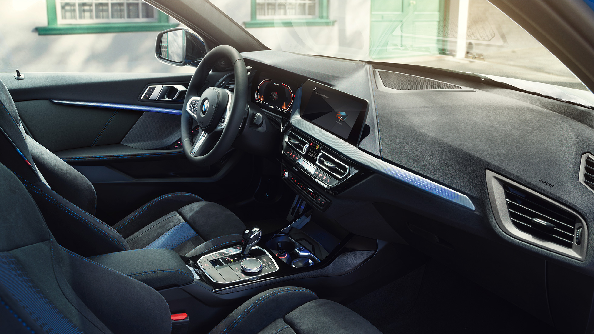 Sporty BMW 1 Series interior. BMW 1 Series cockpit with M Sport seats, M Leather steering wheel and illuminated interior trim finishers.