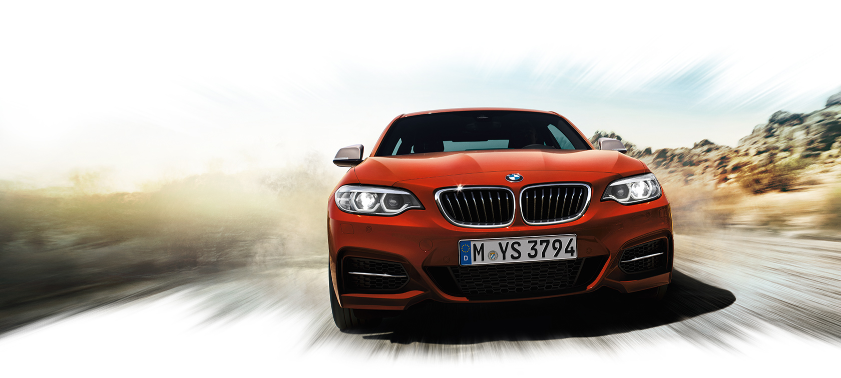 BMW 2-Series Coupe metalic orange front view: dusty road BMW 2-Series Coupe metalic orange front view: dusty road