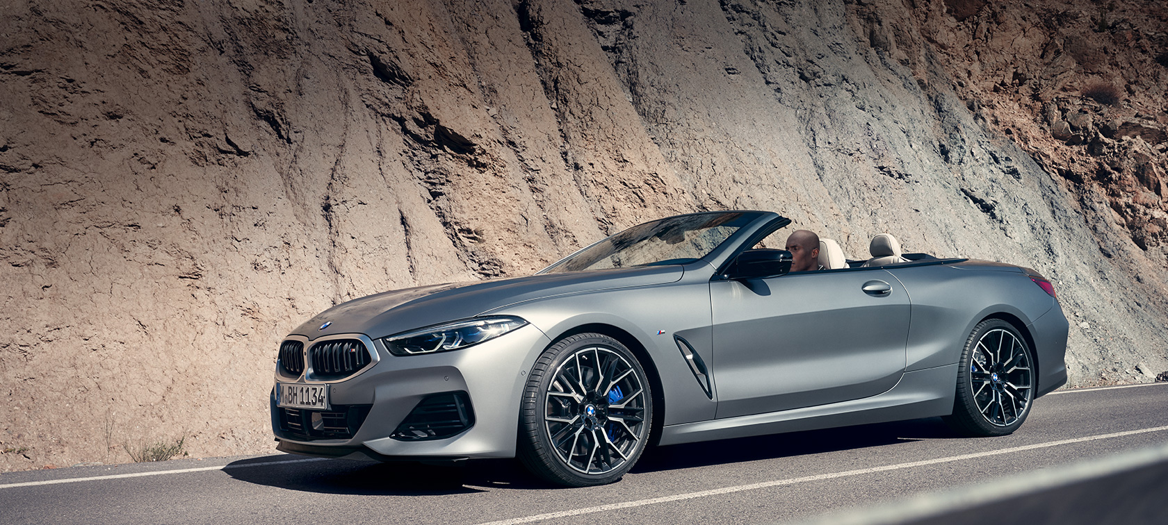 BMW 8 Series Convertible G14 LCI Facelift 2022 the new BMW M850i xDrive BMW Individual Frozen Pure Grey metallic three-quarter side view standing in front of a building BMW 8 Series Convertible G14 LCI Facelift 2022 the new BMW M850i xDrive BMW Individual Frozen Pure Grey metallic three-quarter side view standing in front of a building