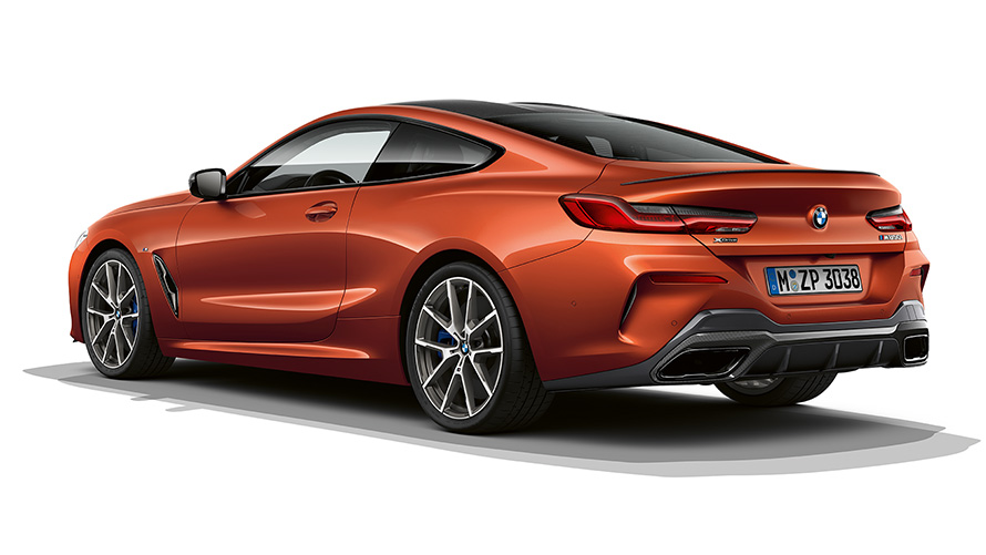 A still shot of the BMW 8 Series Coupé in Sunset Orange metallic against a white background.