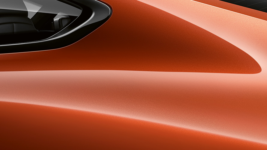 Close-up of the C pillar of the BMW 8 Series Coupé in Sunset Orange metallic.
