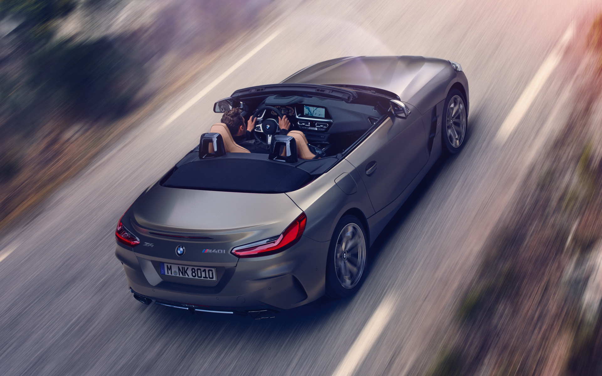 BMW Z4 M40i Roadster G29 2019 BMW Individual Frozen Grey metallic driving with open softtop bird's eye view