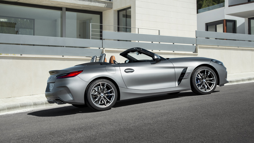 BMW Z4 M40i Roadster G29 side view in front of building BMW Z4 M40i Roadster G29 side view in front of building