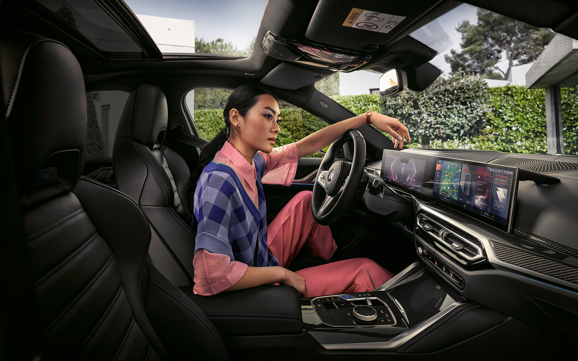 BMW i4 M50 G26 2021 interior with woman in driver's seat