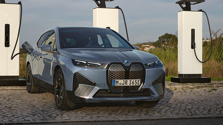 BMW iX M60 i20 2022 electric SUV BMW Individual Storm Bay metallic front view at high-power charging station