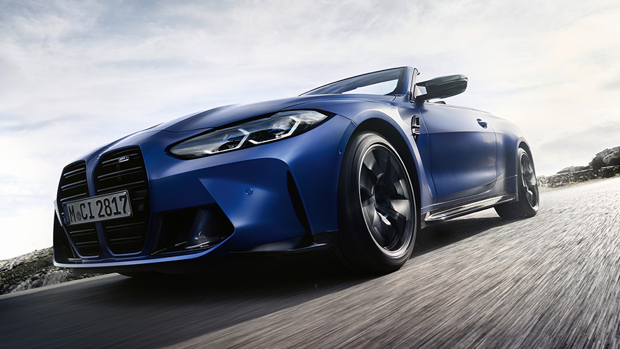 BMW M4 Competition Convertible with M xDrive G83 2021 front view with double kidney grille BMW M4 Competition Convertible with M xDrive G83 2021 BMW Individual Frozen Portimao Blue metallic front kidney gille low angle shot