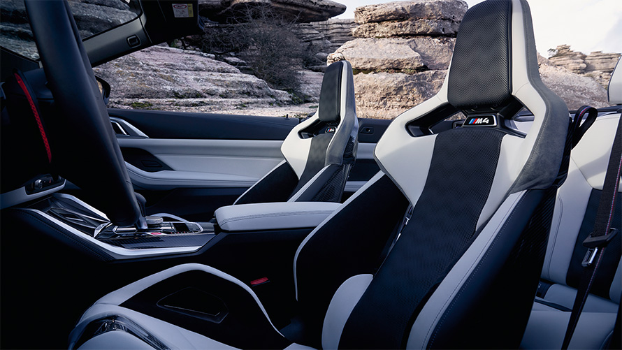 M Carbon bucket seats BMW M4 Competition Convertible with M xDrive G83 2021 interior with open softtop BMW M4 Competition Convertible with M xDrive G83 2021 M Carbon bucket seats interior with open softtop