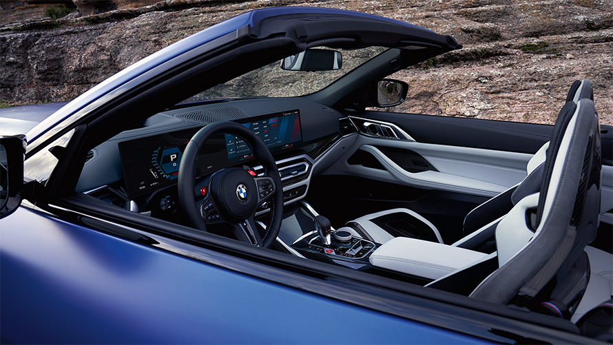 BMW M4 Competition Convertible with M xDrive G83 2021 interior with open softtop BMW M4 Competition Convertible with M xDrive G83 2021 BMW Individual Frozen Portimao Blue metallic cockpit and interior with open softtop