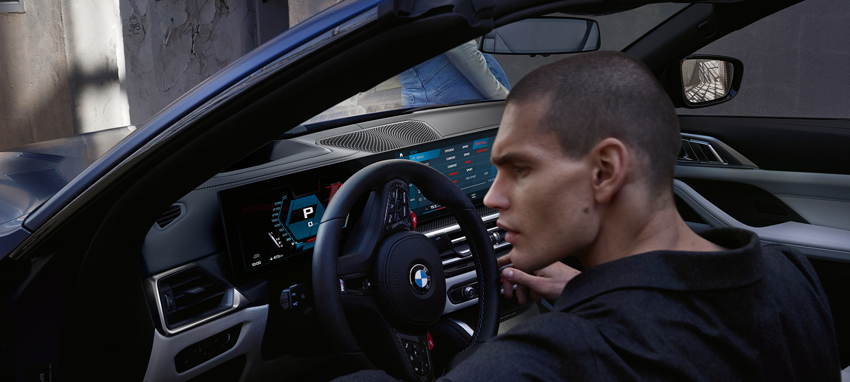 BMW M4 Competition Convertible with M xDrive G83 2021 cockpit BMW M4 Competition Convertible with M xDrive G83 2021 BMW Individual Frozen Portimao Blue metallic cockpit with open door and male model
