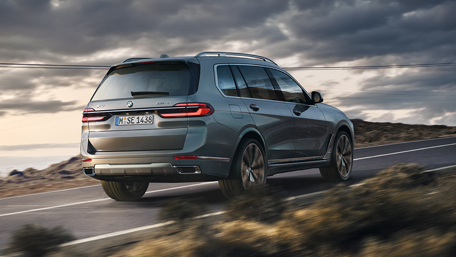 BMW X7 G07 first generation three-quarter rear view driving on the road BMW X Series BMW X7 G07 first generation three-quarter rear view driving on the road