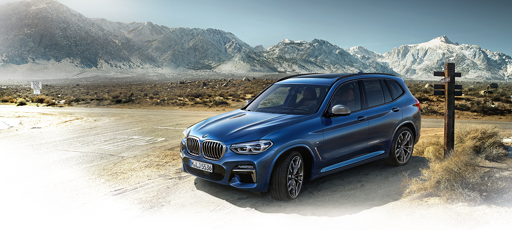 BMW X-Series X3 in bright blue frontside view: mountain road BMW X-Series X3 in bright blue frontside view: mountain road