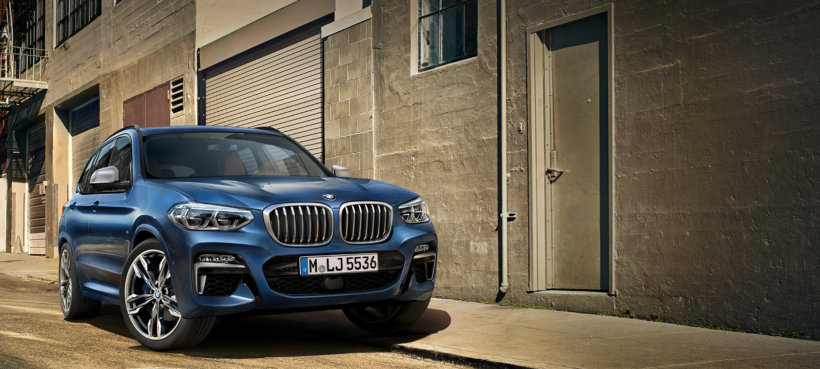 BMW X3 M40i SUV G01, shot in front of house wall BMW X3 M40i SUV G01, shot in front of house wall