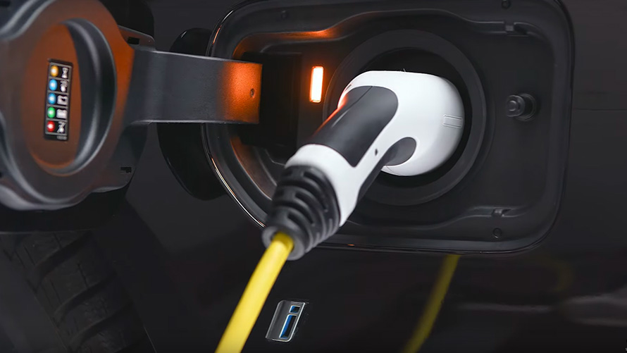 BMW plug-in hybrid connected with charging cable BMW X5 G05 BMW plug-in hybrid connected with charging cable close-up