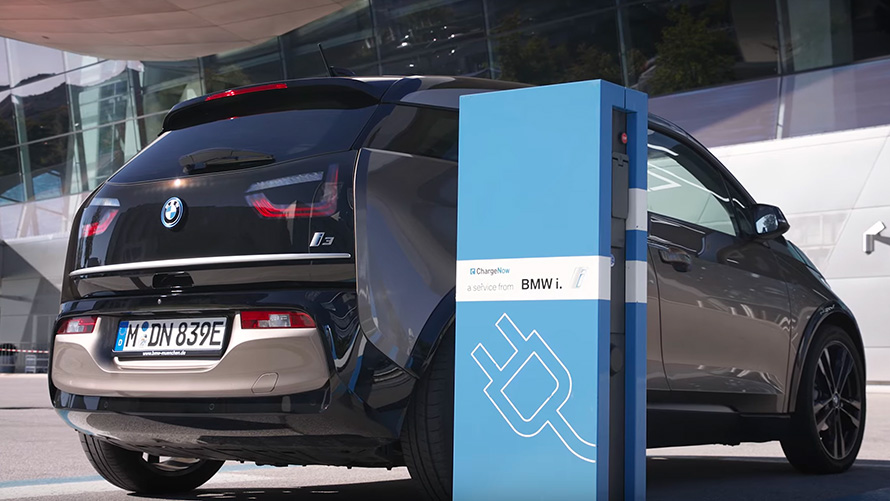 BMW i3 on charging station BMW X5 G05 BMW i3 on charging station three-quarter rear view
