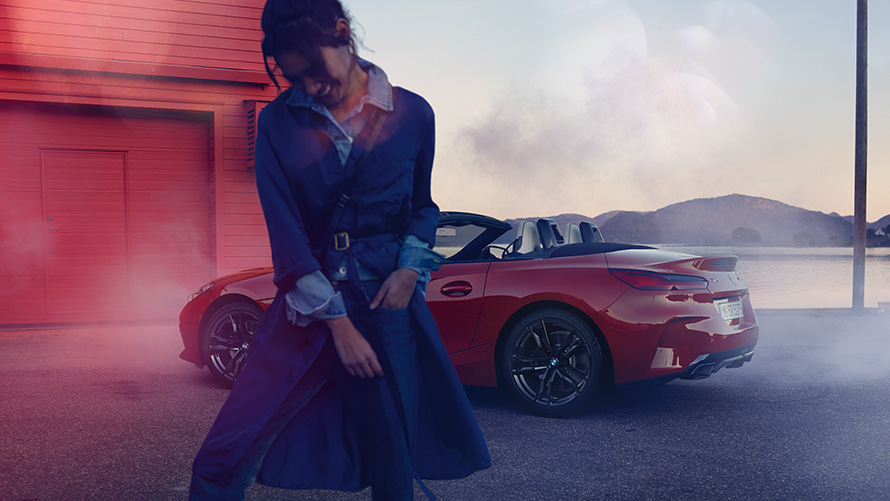 BMW Z4 M40i Roadster G29 with open softtop BMW Z4 M40i Roadster G29 three-quarter rear view with open softtop and woman in the foreground