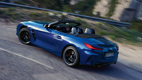 BMW Z4 M40i Roadster (G29) three-quarter rear view driving BMW Z4 M40i Roadster (G29) three-quarter rear view driving