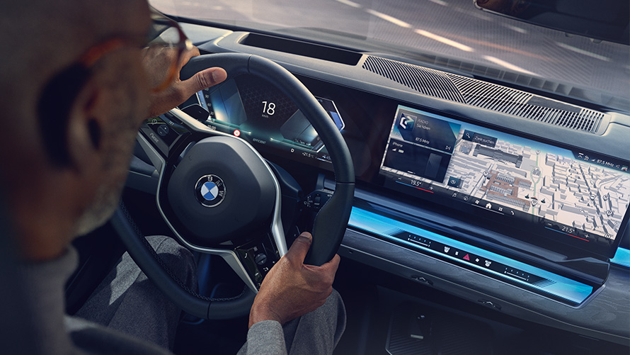 BMW interior man looking at display with Operating System 8.5 BMW interior man looking at BMW Maps on display with Operating System 8.5