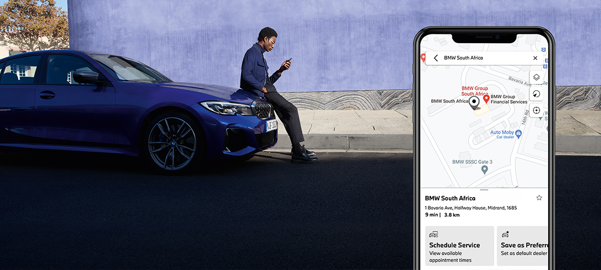 My BMW App manage my service experience man sitting on a bonnet of a BMW My BMW App manage my service experience man sitting on a bonnet of a BMW
